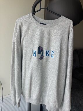 Nike Light Gray Crewneck Sweatshirt with Blue Lettering and Purple Graphic